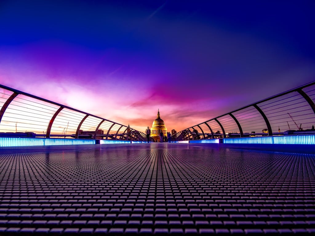 Captivating view of London's Millennium Bridge at sunset with St. Paul's Cathedral in the background.